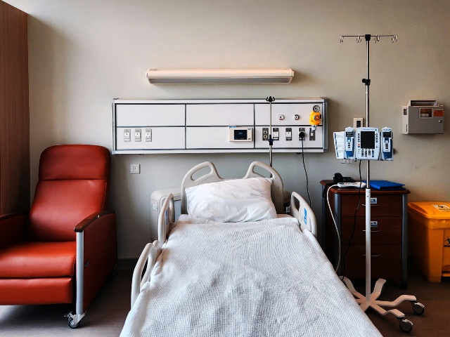 A hospital room with a bed and chair