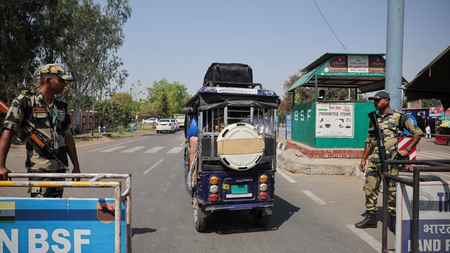 Border Security Force (BSF) soldiers stand guard as a vehicle with Pakistani citizens crosses towards the integrated checkpost as they prepare to leave India after India revoked all visas issued to Pakistani citizens, at the Attari-Wagah border crossing near Amritsar, India, April 26, 2025.