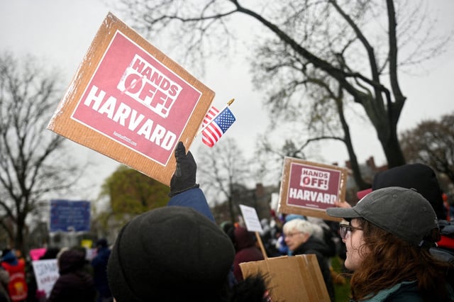 Demonstrators rally April 12 on Cambridge Common during a city-organized protest calling on Harvard leaders to resist interference at the university by the federal government.