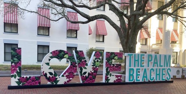 A big sign outside the Florida Capitol in early March promoted Palm Beach County as a popular destination.
