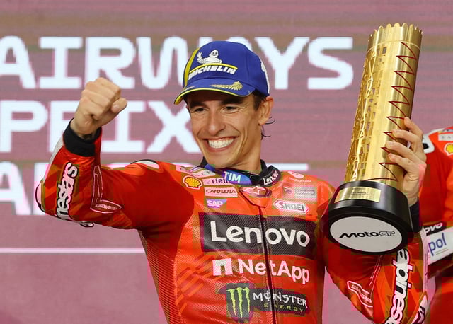 MotoGP - Qatar Grand Prix - Lusail International Circuit, Doha, Qatar - April 13, 2025 Ducati Lenovo Team's Marc Marquez celebrates on the podium with a trophy after winning the Qatar Grand Prix REUTERS/Ibraheem Al Omari/File Photo