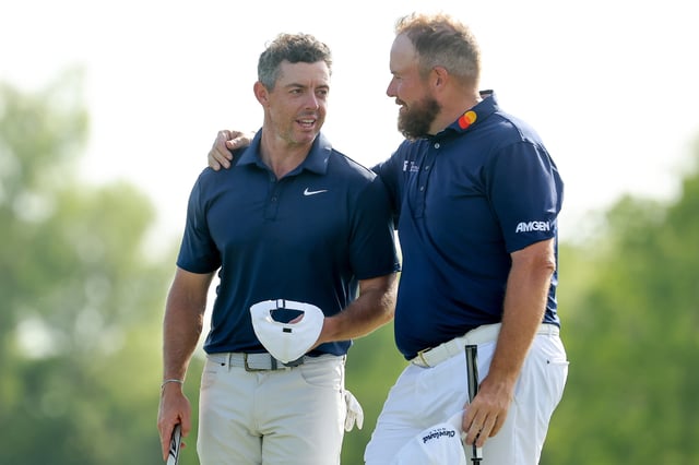 Rory McIlroy of Northern Ireland and Shane Lowry of Ireland watch on the 18th green on day two of the Zurich Classic of New Orleans on April 25, 2025 in Avondale, Louisiana.