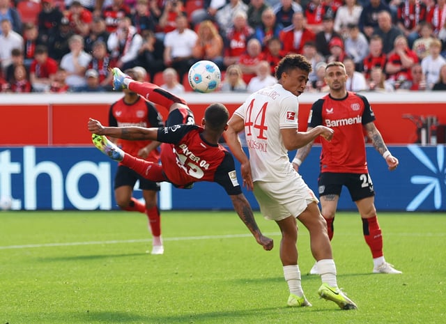 Soccer Football - Bundesliga - Bayer Leverkusen v FC Augsburg - BayArena, Leverkusen, Germany - April 26, 2025 Bayer Leverkusen's Arthur in action with FC Augsburg's Henri Koudossou REUTERS/Thilo Schmuelgen