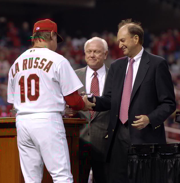 St. Louis Cardinals manager Tony LaRussa #10 receives his World Series ring from Cardinals chairman Bill DeWitt Jr. (R) and general manager Walt Jocketty (C) during a ceremony before the game against the New York Mets at Busch Stadium on April 3, 2007 in St. Louis, Missouri.