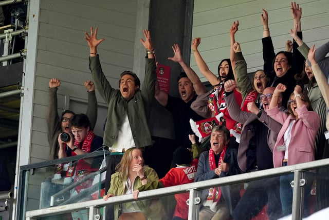 Wrexham co-owners Ryan Reynolds (left) and Rob McElhenney celebrate after Wrexham scored their second goal Saturday.
