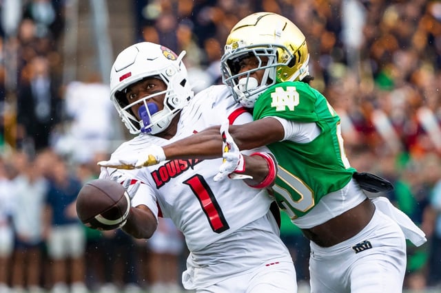 Notre Dame defensive back Benjamin Morrison (20, right) knocks the ball away from Louisville wide receiver Ja&#39;Corey Brooks (1) during the first half of their Sept. 28 game last season in  South Bend, Ind. (AP Photo/Michael Caterina)