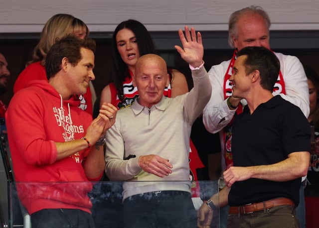 Soccer Football - League One - Wrexham v Charlton Athletic - SToK Racecourse, Wrexham, Britain - April 26, 2025 Actors and Wrexham owners Rob McElhenney and Ryan Reynolds with former Wrexham footballer Mickey Thomas celebrate being promoted to the Championship Action Images via Reuters/Craig Brough
