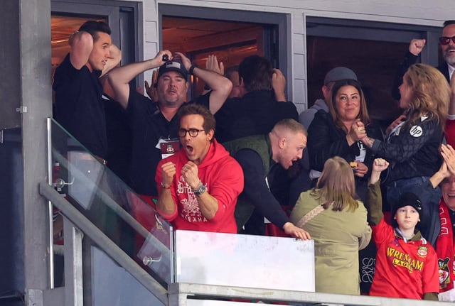 Soccer Football - League One - Wrexham v Charlton Athletic - SToK Racecourse, Wrexham, Britain - April 26, 2025 Actors and Wrexham owners Rob McElhenney and Ryan Reynolds celebrate after Wrexham's Sam Smith scores their third goal Action Images via Reuters/Craig Brough