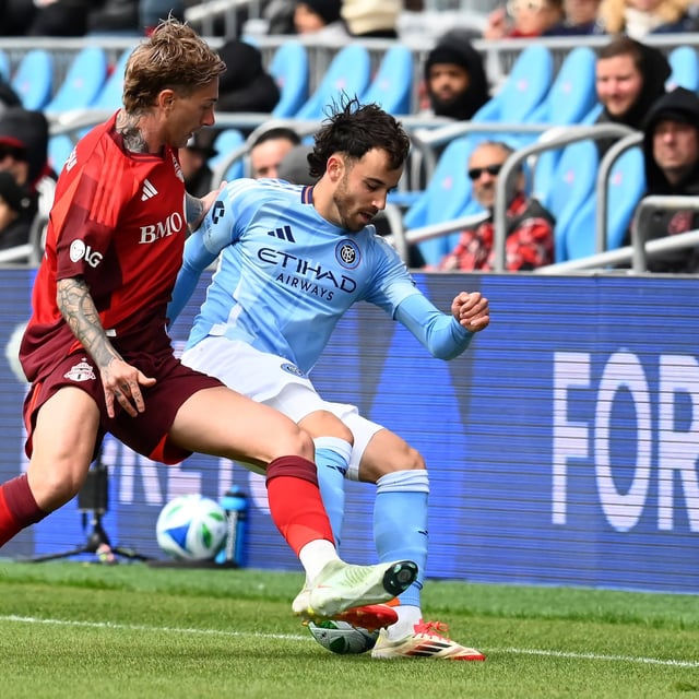 Toronto FC striker Federico Bernardeschi, left, tackles New York City FC’s Kevin O'Toole during first half MLS soccer action in Toronto on Saturday, April 26, 2025. THE CANADIAN PRESS/Jon Blacker