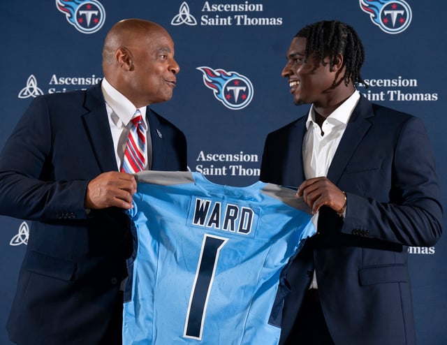 NFL Hall of Fame quarterback Warren Moon, left, poses for pictures with Cam Ward, the Titans' No. 1 overall draft pick.