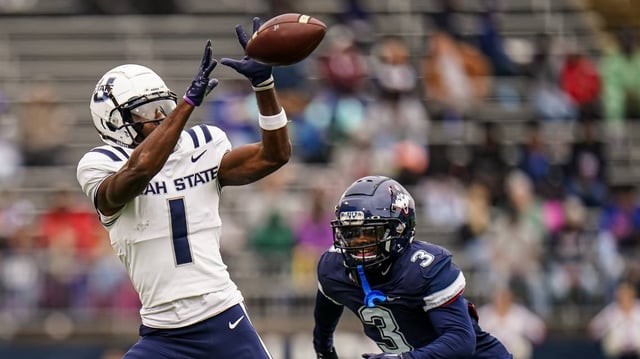 Utah State Aggies wide receiver Jalen Royals (1) makes the catch against UConn Huskies defensive back D’Mon Brinson (3) in the second quarter at Rentschler Field at Pratt & Whitney Stadium on Sept. 30, 2023.