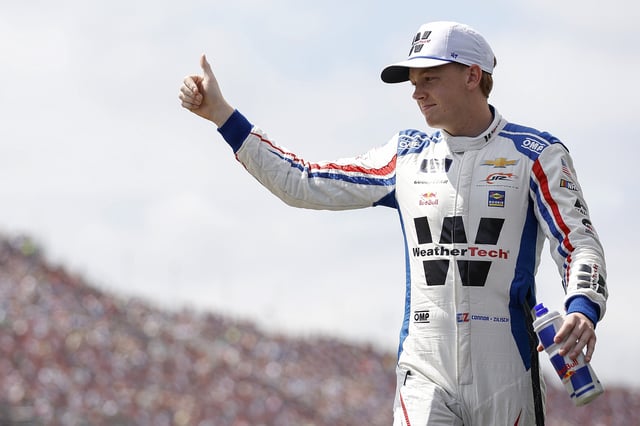 Connor Zilisch, driver of the #88 WeatherTech Chevrolet, gives a thumbs up to fans as he walks onstage during driver intros prior to the NASCAR Xfinity Series Ag-Pro 300 at Talladega Superspeedway on April 26, 2025 in Talladega, Alabama.