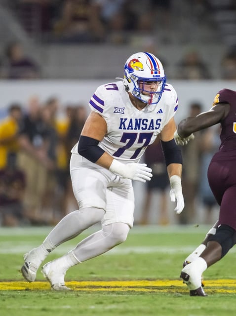 Kansas football offensive lineman Bryce Cabeldue (77) plays against Arizona State during a game on Oct. 5, 2024 at Mountain America Stadium in Tempe, Arizona.