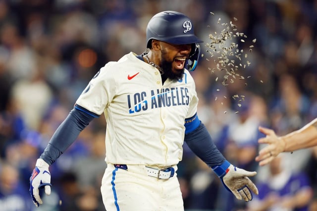 The Dodgers’ Teoscar Hernández is showered with sunflower seeds as he returns to the dugout after hitting a go-ahead solo home run during the eighth inning of their game against the Pittsburgh Pirates on Saturday night at Dodger Stadium. (Photo by Harry How/Getty Images)