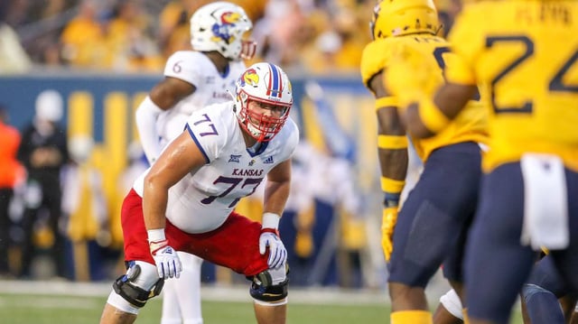 Kansas Jayhawks offensive lineman Bryce Cabeldue (77) pauses before a snap during the second quarter against the West Virginia Mountaineers at Mountaineer Field at Milan Puskar Stadium on Sept. 10, 2022.