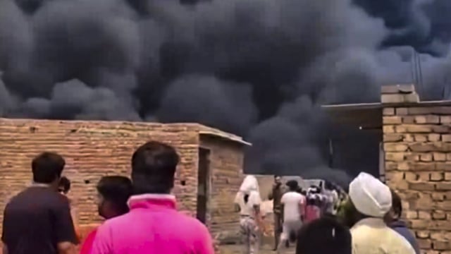 Smoke rises as a fire breaks out at a slum in Delhi's Rohini.