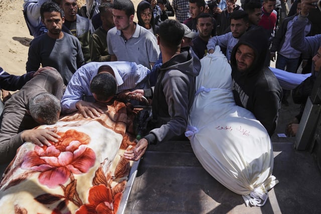 Palestinians mourn over the bodies of their relatives who were killed in an Israeli airstrike, as they brought to Shifa Hospital in Gaza City, on Saturday, April 26, 2025. (AP Photo/Jehad Alshrafi)