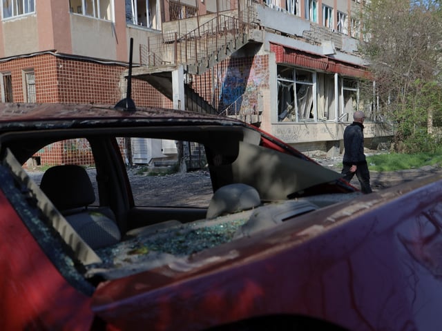 A man walks past a damaged building following a Russian drones strike in Odesa on April 22, 2025, amid the Russian invasion of Ukraine. (Photo by Oleksandr GIMANOV / AFP) (Photo by OLEKSANDR GIMANOV/AFP via Getty Images)