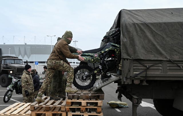 Participants load motorcycles into a truck during a ceremony to hand over to the Russian military in Rostov-on-Don, Russia, November 28, 2024.