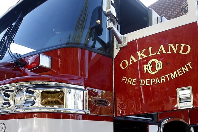 The Oakland Fire Department brought a blaze on the roof of a sewing business under control within about a half-hour Sunday morning. 