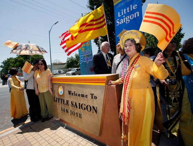 At right, Hoang Xuyen Anh, celebrates the unveiling of a permanent sign welcoming visitors to “Little Saigon” on Story Road near Via Ferrari in San Jose, Calif., on Saturday, May 21, 2011.  (LiPo Ching/Mercury News)