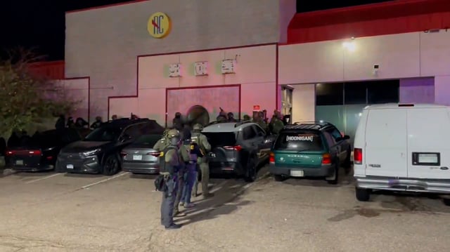 More than 100 people were detained in Colorado Springs following an overnight raid at what authorities described as an underground nightclub in a strip mall, according to the Drug Enforcement Administration. A portion of this image has been blurred by CNN.