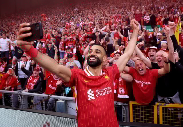 Soccer Football - Premier League - Liverpool v Tottenham Hotspur - Anfield, Liverpool, Britain - April 27, 2025 Liverpool's Mohamed Salah takes a selfie with fans after winning the Premier League REUTERS/Phil Noble