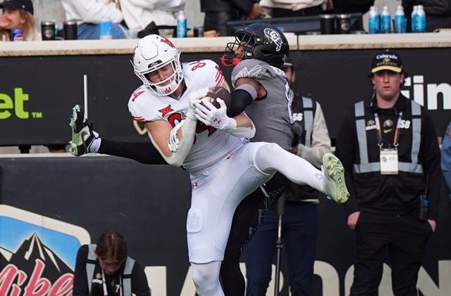 Utah tight end Caleb Lohner (84) pulls in a touchdown pass as Colorado cornerback DJ McKinney (8) defends in the second half of an NCAA college football game Saturday, Nov. 16, 2024, in Boulder, Colo. (AP Photo/David Zalubowski)