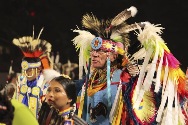 CORRECTS DATE - Native American and Indigenous dancers pack an arena during a grand entry procession at the annual Gathering of Nations powwow in Albuquerque, New Mexico, Friday, April 25, 2025. (AP Photo/Susan Montoya Bryan)