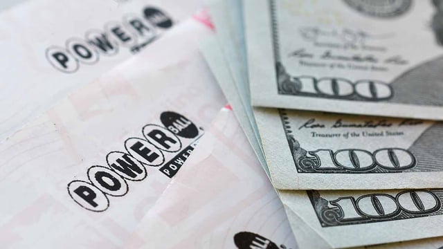 Staunton, VA USA Sept 2, 2021 Powerball Power Ball lottery tickets with hundred dollar bills, winning numbers cash prize
