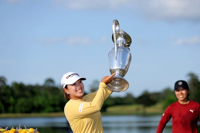 Apr 27, 2025; The Woodlands, Texas, USA; Mao Saigo of Japan raises the championship trophy after winning The Chevron Championship golf tournament. Mandatory Credit: Erik Williams-Imagn Images