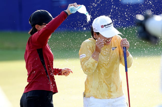 Apr 27, 2025; The Woodlands, Texas, USA; Mao Saigo of Japan is doused with water after making a birdie putt on the first playoff hole to win The Chevron Championship golf tournament. Mandatory Credit: Erik Williams-Imagn Images