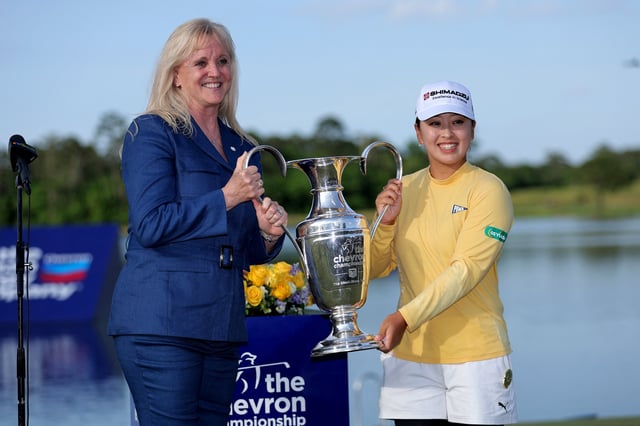 Apr 27, 2025; The Woodlands, Texas, USA; Mao Saigo of Japan is presented with the championship trophy after winning The Chevron Championship golf tournament. Mandatory Credit: Erik Williams-Imagn Images