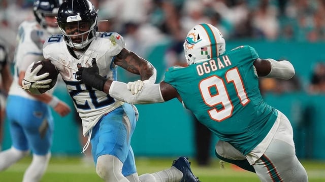 NFL: Tennessee Titans at Miami Dolphins. Sep 30, 2024; Miami Gardens, Florida, USA; Miami Dolphins linebacker Emmanuel Ogbah (91) reaches for Tennessee Titans running back Tony Pollard (20) during the second half at Hard Rock Stadium. Mandatory Credit: Jasen Vinlove-Imagn Images