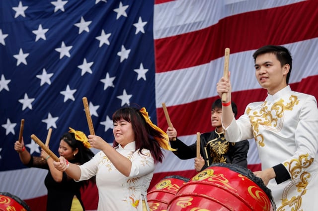A Vietnamese dance troupe performs during the 50th anniversary of Operation Frequent Wind and the fall of the Republic of Vietnam aboard the USS Midway on Sunday. The tribute honored the courage, resilience, and hope for those who fled their Vietnamese homeland, the communities that welcomed them, and the lasting contributions of Vietnamese refugees across the United States and the world.(Photo by Sandy Huffaker for The San Diego Union-Tribune)
