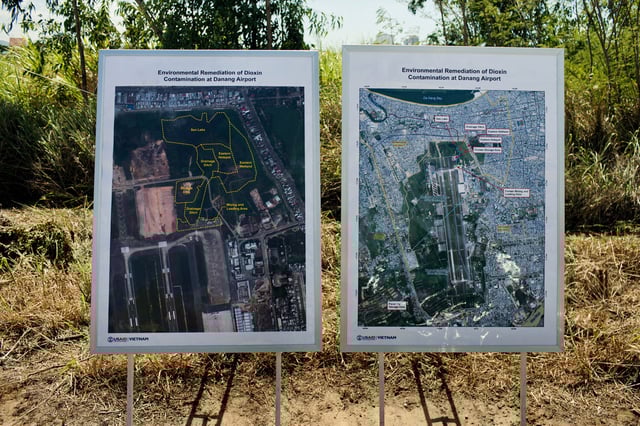 FILE- Maps of the area contaminated with dioxin around Danang airport are displayed during a ceremony marking the start of a project to clean up dioxin left over from the Vietnam War, at a former U.S. military base in Danang, Vietnam Thursday Aug. 9, 2012. (AP Photo/Maika Elan, File)