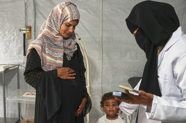 Islam Qeshta, a 30-year-old pregnant Palestinian woman, arrives for a prenatal checkup at the MSF clinic in Muwasi, near Khan Younis, in the southern Gaza Strip, on Wednesday, April 9, 2025. (AP Photo/Abdel Kareem Hana)