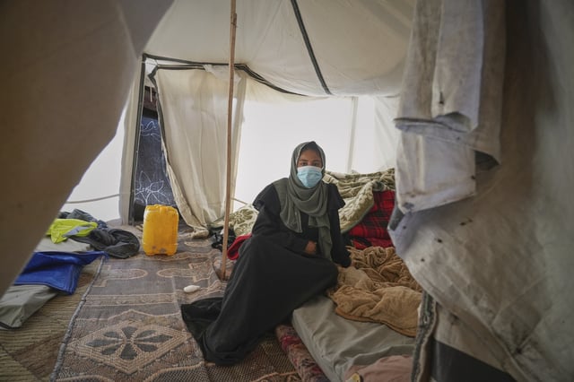 Palestinian woman Yasmine Siam, who was pregnant but suffered a miscarriage a few days later, poses for a photo in her tent in Khan Younis, southern Gaza Strip, Wednesday, April 9, 2025. (AP Photo/Abdel Kareem Hana)