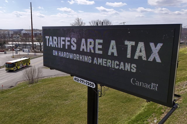 FILE - A digital bill board flashes a message in Kennedy Township, Pa., March 25, 2025. (AP Photo/Gene J. Puskar, File)