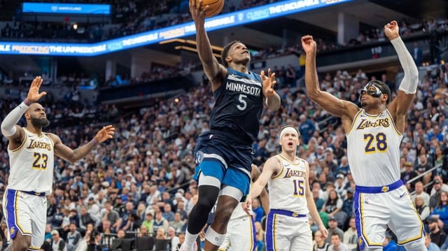 Minnesota Timberwolves guard Anthony Edwards (5) shoots with Los Angeles Lakers forward Rui Hachimura (28) on defense in the third quarter during game four of first round for the 2025 NBA Playoffs at Target Center.