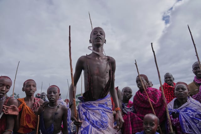Children of the Maasai tribe perform a traditional jumping dance during the Enkipaata ceremony, a Maasai male rite of passage, specifically the initiation of boys, marking the transition from childhood to becoming a moran (warrior) in Olaimutiai, Narok County, Kenya, Thursday, April 24, 2024. (AP Photo/Brian Inganga)
