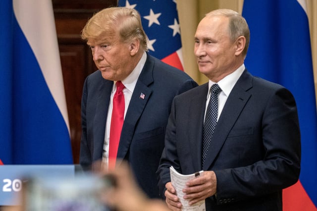 U.S. President Donald Trump (L) and Russian President Vladimir Putin arrive to waiting media during a joint press conference after their summit on July 16, 2018 in Helsinki, Finland.