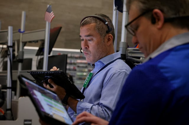 A futures-options trader works on the floor at the American Stock Exchange (AMEX) at the New York Stock Exchange (NYSE) in New York City, U.S., April 24, 2025.  REUTERS/Brendan McDermid/File Photo