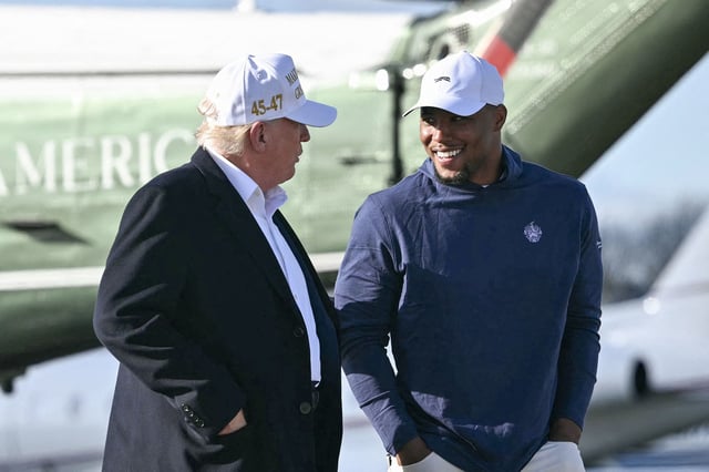 US president Donald Trump (left) walks with Philadelphia Eagles running back Saquon Barkley (right) at Morristown, New Jersey.
