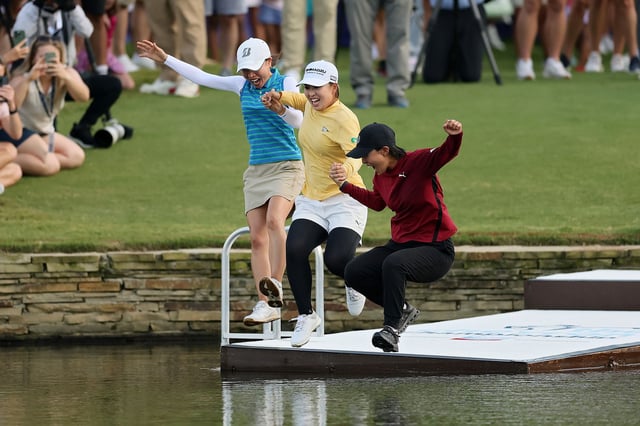 THE WOODLANDS, TEXAS - APRIL 27: Mao Saigo of Japan (C) jumps in the pond on the 18th hole after winning The Chevron Championship 2025 in a playoff at The Club at Carlton Woods on April 27, 2025 in The Woodlands, Texas. (Photo by Alex Slitz/Getty Images)