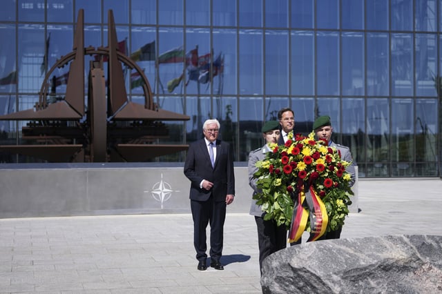 Germany's President Frank-Walter Steinmeier, center, and NATO Secretary General Mark Rutte, right, participate in a wreath laying ceremony to mark the 70th anniversary of Germany's accession to NATO at NATO headquarters in Brussels, Monday, April 28, 2025. (AP Photo/Virginia Mayo)