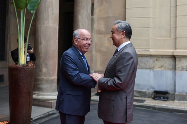 Brazilian Foreign Minister Mauro Vieira and Chinese Foreign Minister Wang Yi shake hands, on the day of the BRICS Meeting of Ministers of Foreign Affairs in Rio de Janeiro, Brazil, April 28, 2025. REUTERS/Pilar Olivares