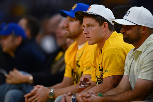 San Francisco 49ers running back Christian McCaffrey sits court side in the first half of Game 3 of the Western Conference First Round NBA Playoffs game at Chase Center in San Francisco, Calif., on Saturday, April 26, 2025. (Jose Carlos Fajardo/Bay Area News Group)