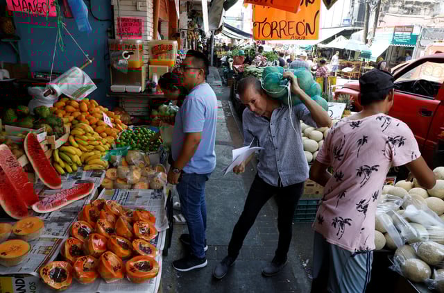 People buy products at a stall in a market in Monterrey, Mexico May 16, 2024. REUTERS/Daniel Becerril/File photo