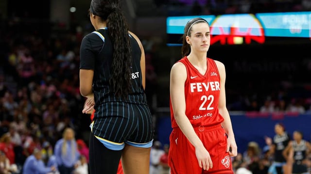 Chicago Sky forward Angel Reese walks by Indiana Fever guard Caitlin Clark during a matchup in August 2024 at Wintrust Arena. Kamil Krzaczynski-Imagn Images